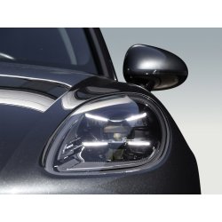 Headlight detail of a black premium vehicle for professional car retouching.