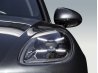 Headlight detail of a black premium vehicle for professional car retouching.